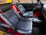 two seats in the back of a car that is red and black
