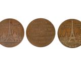three bronze coins with the eiffel tower and the eiffel tower on them