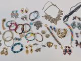 many different types of jewelry on a white surface