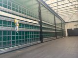 an image of a large warehouse with a green wall