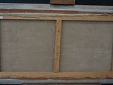 an old picture frame with a piece of wood sticking out of it