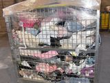 a large metal cage filled with lots of clothing
