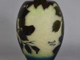 a vase with a leaf design on it on a table