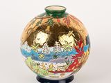 a vase that has a gold and blue design on it