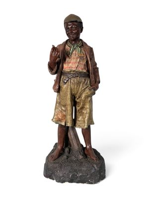bronze statue of a man with a hat and jacket on a rock