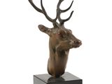 sculpture of a deer head with antlers on a black base