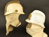 two helmets are sitting next to each other on a black surface