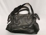 black leather handbag on a white background with a black strap