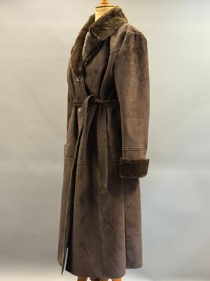 a brown coat with a fur collar on a mannequin stand