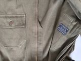 the jacket is green and has a brown zipper on the front