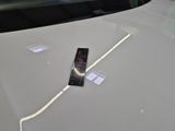 a remote control sitting on the hood of a car