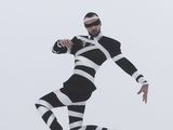 a man in a black and white striped suit running