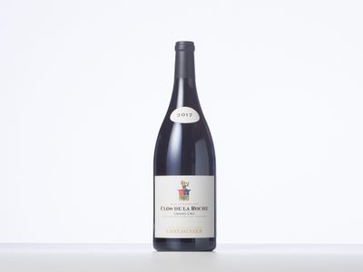 a bottle of red wine sitting on top of a table