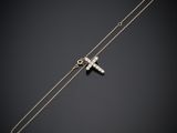 a silver cross on a chain on a black background
