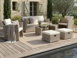 a patio with a table, chairs, umbrella, and a pool