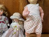 three dolls sitting next to each other on the floor