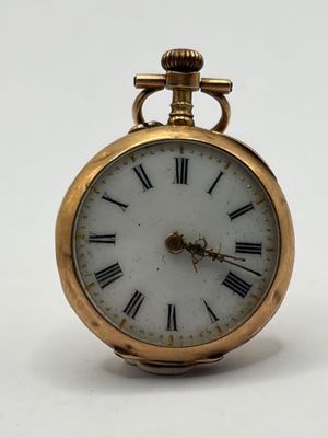 a gold pocket watch with roman numerals on the face