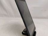 a close up of a tablet computer on a stand on a white surface