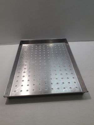a metal tray with holes on it on a table