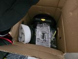 a cardboard box with a brush and other items inside of it