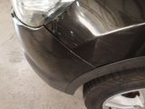 a close up of a car ' s headlight and front bumper