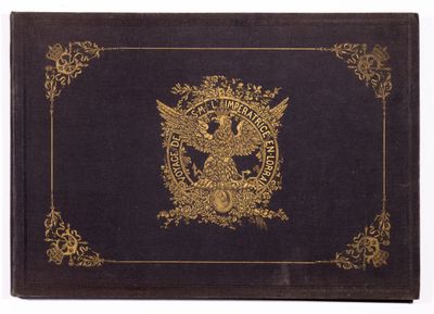 an old book with a gold eagle on it sitting on top of a table