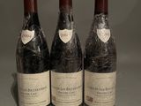 three bottles of wine sitting on top of a table next to each other