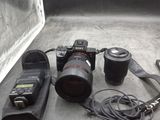a camera, a lens, a camera case and a camera on a table