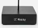 a clock on a stand that reads j rizz