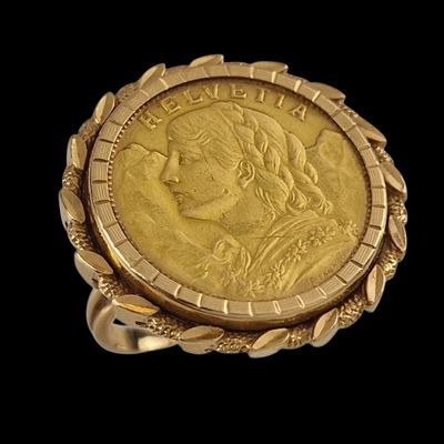 a close up of a gold coin in a ring on a black background