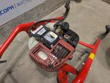 an image of a lawn mower with a red handle