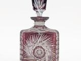 a red glass bottle with a starburst design on it