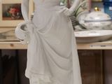 a statue of a woman standing on a table