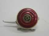 an image of a red and gold fishing reel