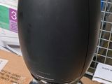 a black egg sitting on top of a box in a store
