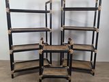 three black and wicker bookshelves are stacked on top of each other