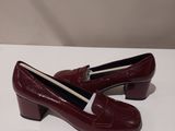 a close up of a pair of red shoes on a white surface