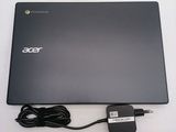 a black laptop with a charger attached to it