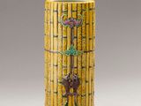 an image of a yellow vase with a key on top of it