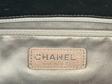 a close up of a chanel bag with a tag on it