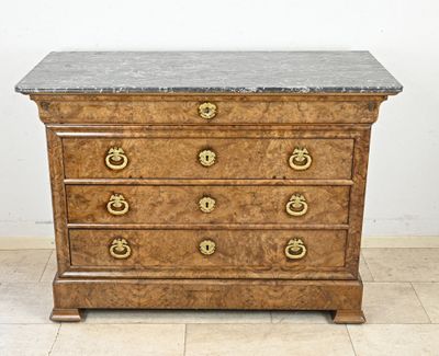a marble top chest of drawers on a tiled floor