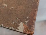 an old book sitting on top of a glass table