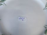 a white plate with yellow flowers on it on a table