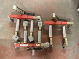 four different types of rollers are on the floor in a warehouse