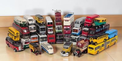 a lot of toy buses that are sitting on the floor