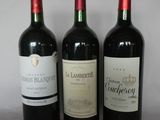 three bottles of wine sitting next to each other on a table