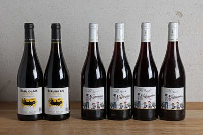 six bottles of wine are lined up on a wooden table