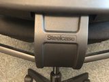 the back of a steelcase office chair with a black seat