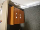 a cabinet that has two eyes on it in the corner of a room