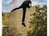 an image of a man on a skateboard in the air above a building
